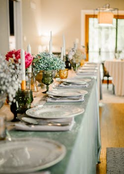 Stylish indoor dining table with floral arrangements for a wedding reception.
