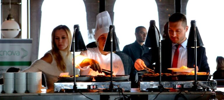 Business professionals enjoying a buffet meal in a contemporary indoor restaurant setting.